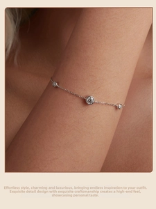 Close-up of three round moissanite stones on a slim S925 sterling silver chain bracelet