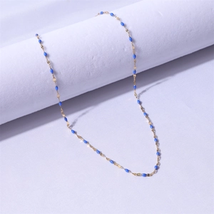 Macro detail of gold-plated stainless steel chain with blue enamel olive leaf charms