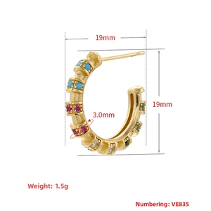 Detail view of C-shaped 18K gold plated earring with colorful cubic zirconia and bamboo texture
