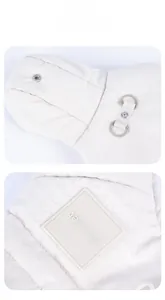 Macro detail of padded pet coat showing quilted texture with D-ring and metal buttons