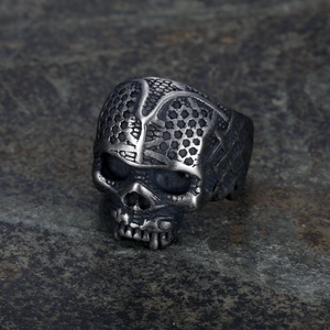 Punk style men's stainless steel skull ring with snake scale texture on a dark background