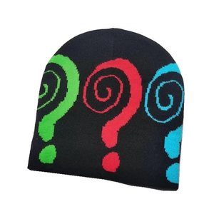 Detailed close-up of a black knit beanie with colorful spiral question mark embroidery