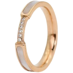 Rose gold titanium ring with white shell inlay and pavé crystals on a minimalist band