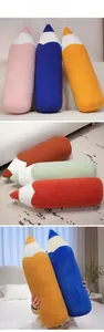 Detailed view of colorful plush pencil cushions in soft sherpa and corduroy fabrics