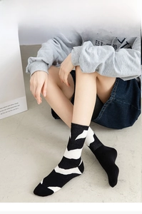 Detail of zebra pattern crew socks with ribbed cuffs and monochrome abstract design