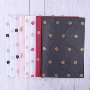 Flat lay of polka dot tissue paper sheets for floral bouquet and gift wrapping