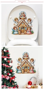 Detailed view of gingerbread house Christmas decals with angels on toilet seat and wall decor