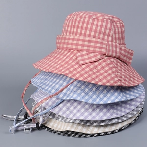 Detail showing various plaid sun hats with matching bows and adjustable windproof cords