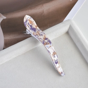 Macro detail of acetate duckbill hair clip with purple and beige marble pattern