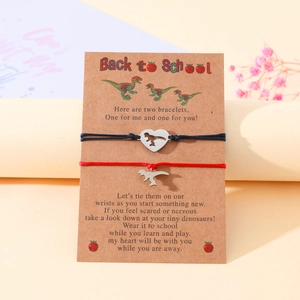 Detail of dinosaur heart bracelets on a Back to School card with black and red ropes