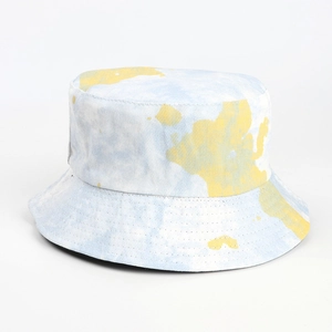 Detailed view of light blue and yellow tie-dye cotton fabric texture on sun bucket hat