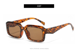 Detail view of square leopard print sunglasses with thick frames and brown tinted lenses