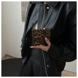 Detailed close-up of leopard print three-fold wallet with fine leather texture