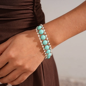 Close-up of Bohemian triple-row bangle with turquoise stones and white rhinestones