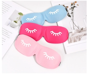 Detailed view of blue, rose and pink 3D sleep masks with eyelash embroidery