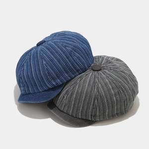 Blue and gray washed denim newsboy caps with vintage vertical striped texture and buttons