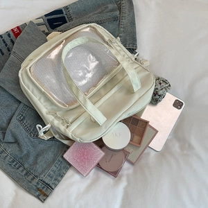 Off-white canvas ita bag with transparent PVC window and adjustable straps for commuters