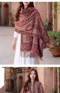 Dettaglio macro del motivo paisley etnico su uno scialle boho rosso in finta cashmere