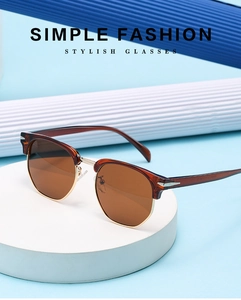 Detail of retro semi-rimless sunglasses with tortoise frame and gold metal hinges