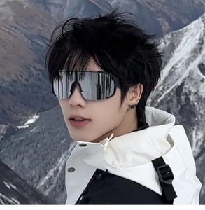 Outdoor cycling goggles with silver mirrored lenses and black frame on a snowy mountain