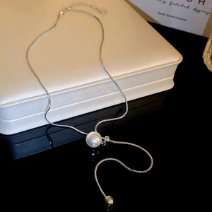 Detailed view of elegant silver snake chain necklace featuring a white round pearl pendant