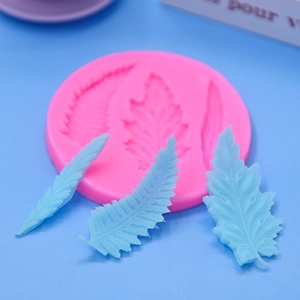 Pink silicone mold featuring three distinct leaf textures for cake fondant or DIY baking
