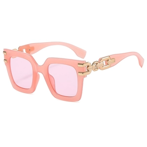 Pink oversized square sunglasses with gold metal chain temples on a clean white background