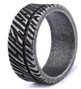 Detailed view of wide retro silver ring with industrial tire tread texture and oxidized finish