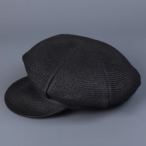 Close-up of the fine woven texture and structured brim on this black newsboy cap