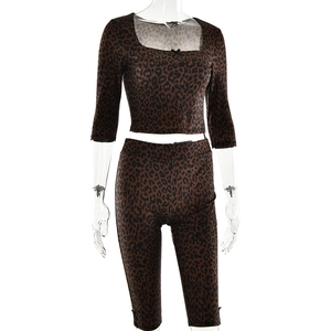 Detail shot of leopard print two-piece set featuring long-sleeve crop top and biker shorts