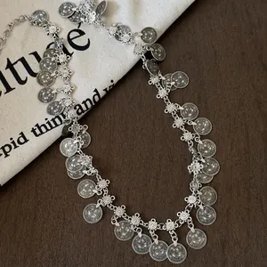 Detail view of retro bohemian waist chain with coin tassels and antique silver finish