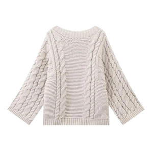 Flat lay of an oversized beige knitted sweater with chunky cable stitch patterns