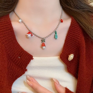 Christmas tree heart necklace with enamel charms on a silver bead chain worn by a model