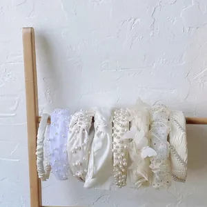 Elegant set of 8 white pearl and bow headbands for women featuring diverse vintage designs