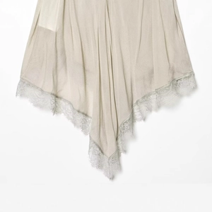Elegant champagne silk skirt with intricate lace hem and premium satin finish detail