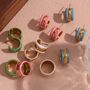 Close-up of gold-plated water ripple rings and earrings with vibrant enamel drip finish