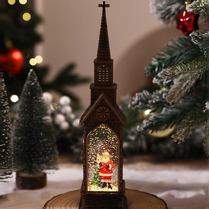 Detail of vintage bronze church snow globe lantern with Santa and swirling gold glitter