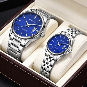 Close-up of a pair of KINGNUOS quartz watches with blue dials and silver steel straps