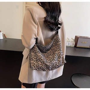 Leopard print tote bag showing casual shoulder carry style over a beige blazer