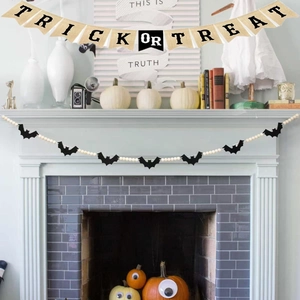 Close-up of Halloween wooden bead garland and Trick or Treat banner on a cozy fireplace