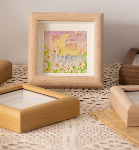 Detail of square oak frame with 3D oil pastel art featuring moon and floral relief