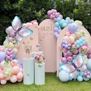 Outdoor setup featuring Macaron balloon arch with 260 metallic twists and butterfly accents