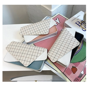 Close-up of color-block flap bags with plaid patterns and premium PU leather textures