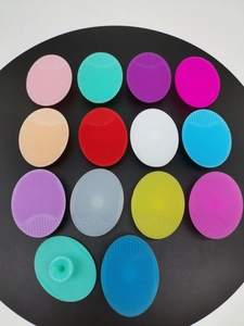 Detailed view of colorful silicone face brushes featuring fine bristles and suction cup handles