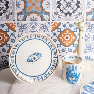 Detailed ceramic tableware set featuring gold-rimmed evil eye and hand of Fatima patterns
