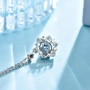Macro detail of S925 sterling silver snowflake pendant with blue zircon center