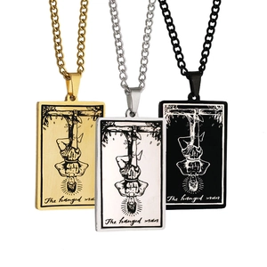 Detailed view of tarot cards pendants in gold silver and black with The Hanged Man design