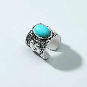 Vintage silver-tone wide band ring featuring a blue turquoise stone in a woven design