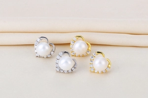 Close-up of heart-shaped S925 silver earrings with natural pearls and zircon details