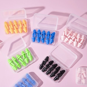 Close-up of colorful silicone earplugs in clear cases for sleeping and noise reduction
